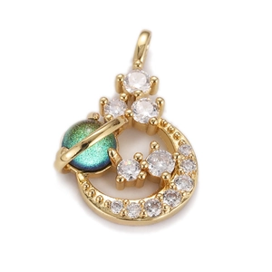 Detailed shot of a crescent moon pendant with green opal and sparkling zircon stones