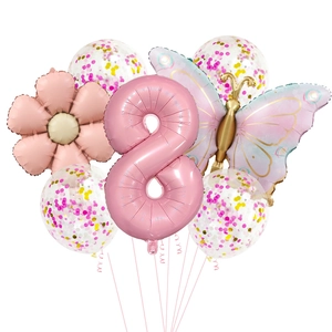 Close-up of pink number 8 balloon with butterfly and floral decorations for birthday parties