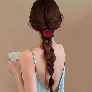 Retro red rose hair tie with black lace, shown as a hair accessory for low ponytail styling