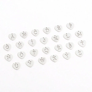 Detail of silver heart-shaped alphabet pendant charms set with A-Z hollow letter design