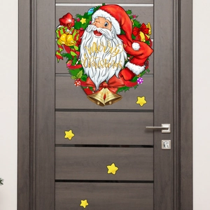 Détail d'un sticker mural Père Noël et couronne sur porte en bois pour décoration