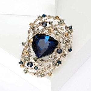 Vintage nest brooch with deep blue triangle stone and sparkling crystals on silver frame