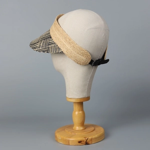 Detail of adjustable leather strap and two-tone raffia weave on sun visor hat