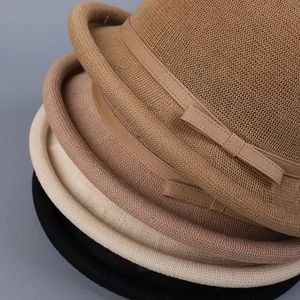 Detail of stacked knitted hats in four colors with elegant bow and rolled brim