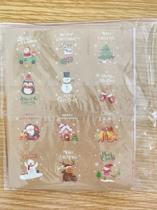 Detail of Christmas round kraft paper stickers featuring Santa and Reindeer holiday motifs
