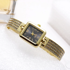 Detail view of square gold watch for women with rhinestone-studded bangle band