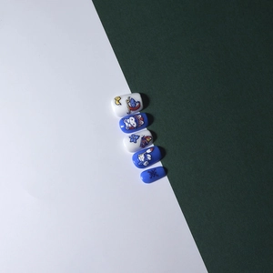 Macro detail of 5D embossed nail stickers with Peking Opera rabbits and floral motifs