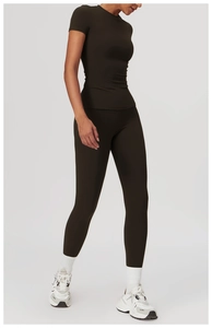 Detail view of a slim-fit dark brown yoga set including tight T-shirt and high-waist leggings