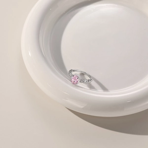 Macro detail of S925 silver ring with beaded band and oval pink cubic zirconia stone
