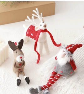 Close-up of wool felt Christmas reindeer and gnome figurines on a rustic tabletop
