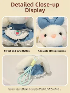 Detail of white plush rabbit charm in denim dress with lace trim and strawberry patch