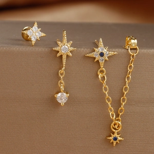 Star-themed gold earrings set with micro-paved zircons and delicate tassel chains