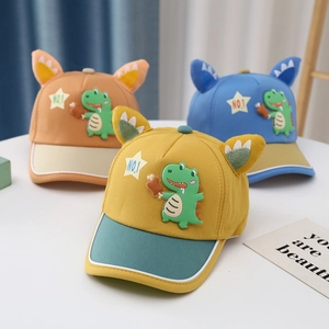 Detailed close-up of three colorful cotton kids baseball caps with dinosaur patches