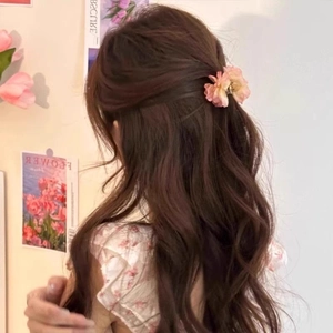 Pink rose flower hair claw clip shown on back of head for a stylish hairstyle