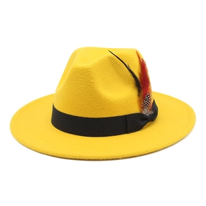 Close-up of a yellow wool fedora hat featuring a black ribbon and decorative feathers