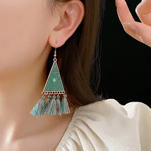 Bohemian triangle earrings with green enamel geometric patterns and long fringe tassels