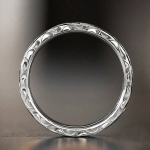 Detailed close-up showing relief floral patterns on a vintage silver textured ring band