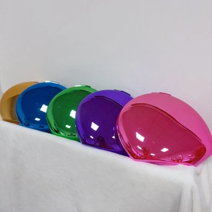 Macro view of five colorful mirror-finish metal clutch bags in oval shape on velvet
