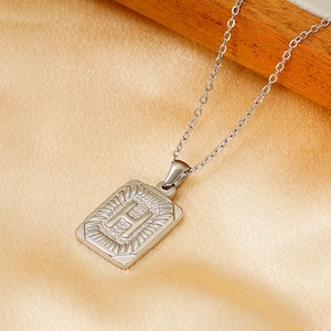 Silver stainless steel square pendant necklace with embossed letter H on silk fabric