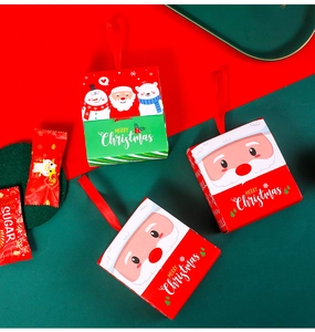 Close-up of festive red and green Christmas candy boxes with ribbons and cartoon motifs