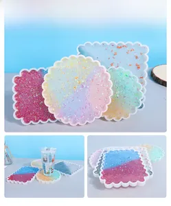 Macro shot of wavy DIY resin coasters with decorative gold foil and glitter finish
