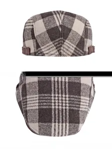 Detail of plaid newsboy cap with metal buckle and thick brown woolen fabric texture
