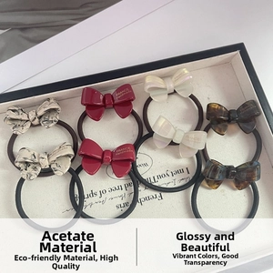 Detailed set of eight handmade acetate bow hair ties with elegant marble and pearl finishes