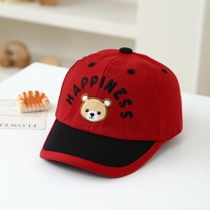Detail view of red and black baseball cap featuring bear and Happiness embroidery