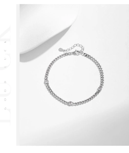 Macro detail of S925 sterling silver Cuban link bracelet with three round cut cubic zirconia