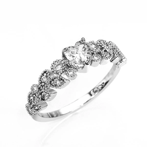 Detailed macro view of S925 sterling silver ring with heart-cut cubic zirconia and engravings