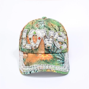 Detailed view of colorful floral baseball cap with LOVE rhinestone and pearl embellishments