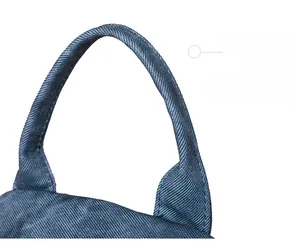 Detail of reinforced navy blue nylon handle with fine stitching on women's backpack