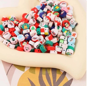 Close-up of festive Christmas polymer clay beads featuring Santa and snowman patterns