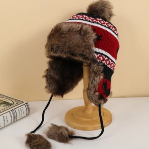 Detail of winter trapper hat with reindeer knit pattern and brown faux fur lining