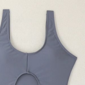 Detail of dark blue swimsuit with U-neck, wide straps and stylish cutout design