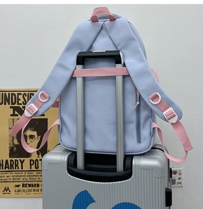 Detail of the purple school backpack showing a convenient luggage strap for travel use