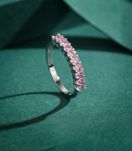 Macro shot of 925 sterling silver ring featuring nine oval-cut pink zircon gemstones