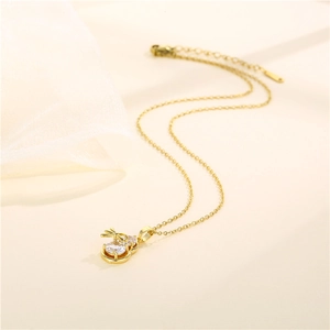 Elegant gold stainless steel necklace featuring a zircon-encrusted gourd pendant on fabric