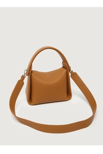 Detail of brown leather handbag featuring lychee texture and silver hardware accents