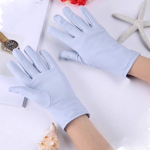 Close-up of light blue spandex sun gloves with scalloped edge stitching and summer decor
