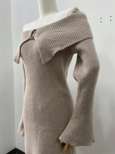 Detail of camel off-shoulder knitted dress showing vertical ribbed texture and flared sleeves