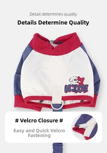 Detailed macro view showing the velcro closure on waterproof dog pants with cartoon patterns