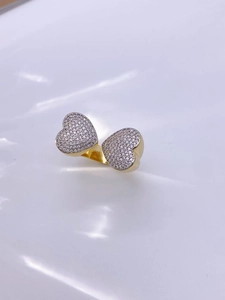 Macro shot of double heart open ring with sparkling pavé cubic zirconia in gold