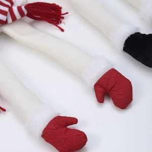 Detail of Christmas elf scarf showing red striped legs and white plush fabric materials
