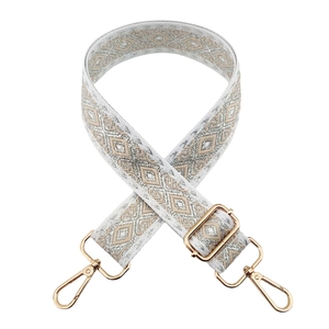 Close-up of adjustable woven shoulder strap with diamond pattern and gold hardware