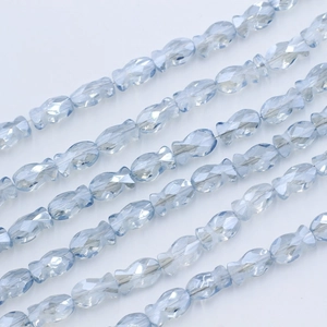 Macro detail of light blue fish-shaped faceted crystal glass beads for DIY jewelry making