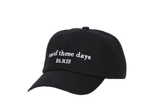 Detail of white Faris embroidery on a premium black cotton canvas baseball cap