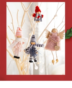 Detailed view of handmade Christmas angel dolls with sequin wings on lighted branches