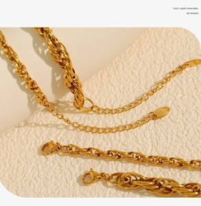 Macro shot of gold-plated twisted rope chain necklace with a secure lobster clasp