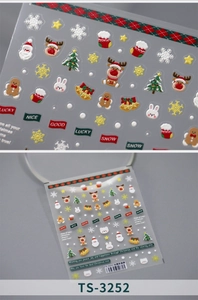 Macro shot of 5D embossed Christmas nail stickers featuring Santa and reindeer details